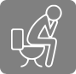 Persona asseguda al wc